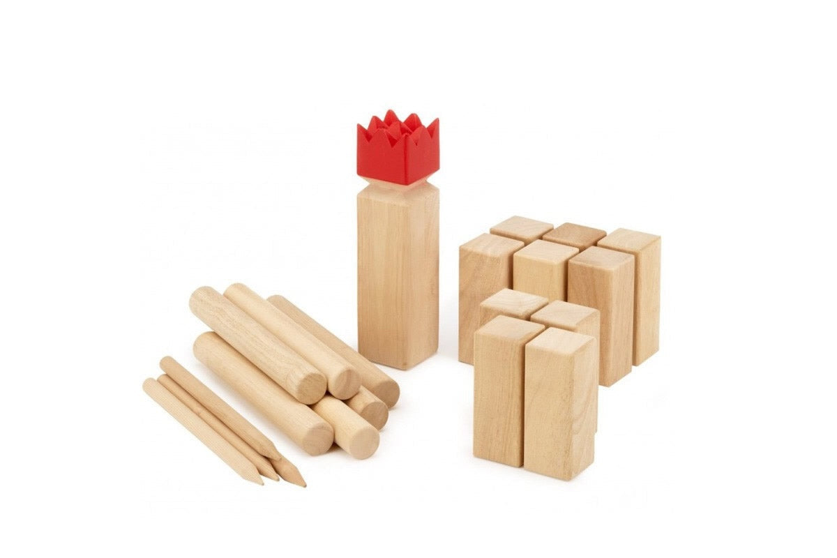 Kubb game played on sandy surface