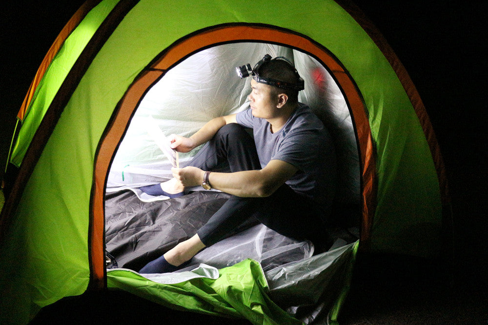 Headlamp worn by camper at night