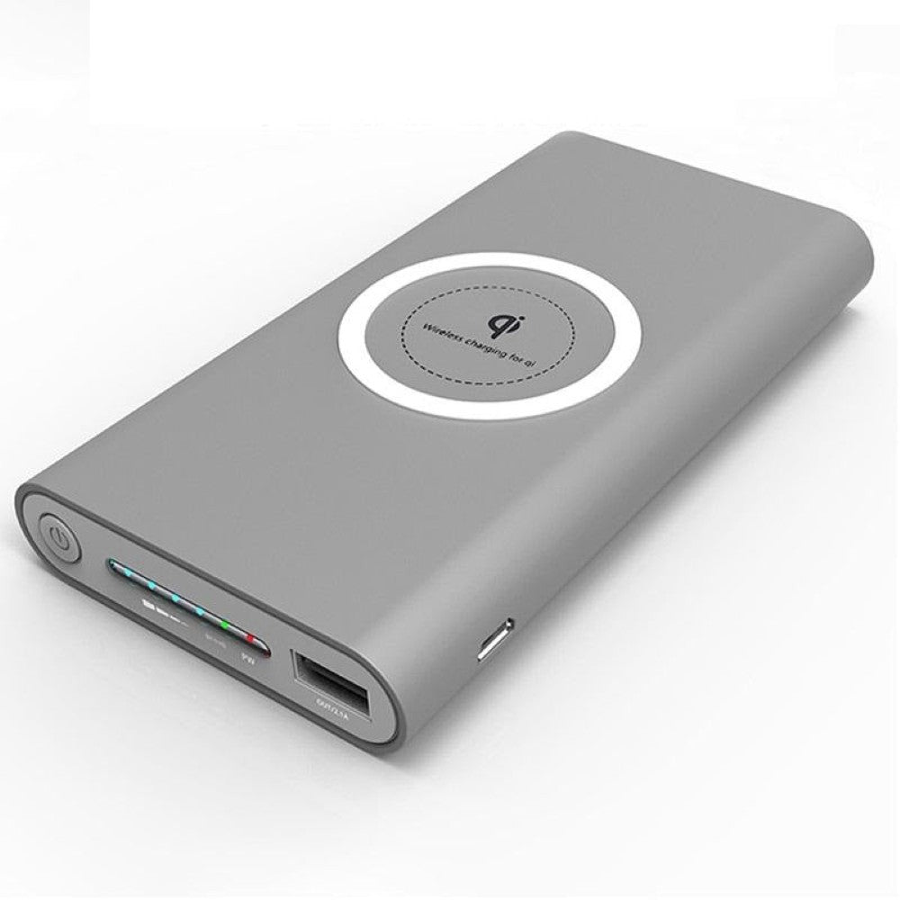 Power bank charging phone wirelessly on flat surface