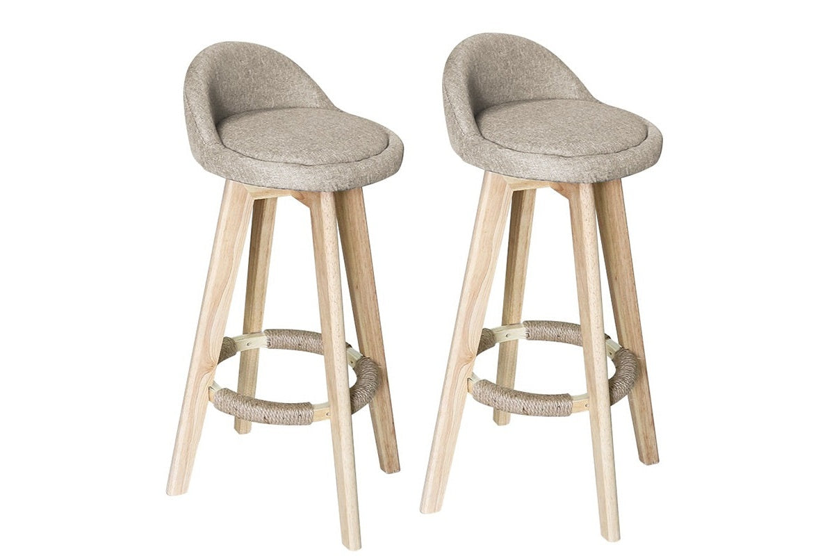 Side angle of beige bar stool with chrome footrest