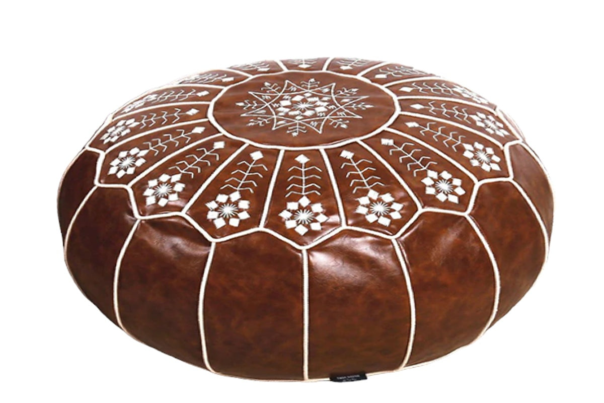 Pouf footrest in hotel room setting