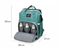 Thumbnail for Folded nappy bag converted to baby travel bed
