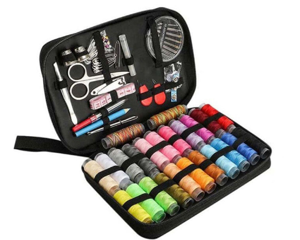 Sewing kit with colourful thread reels in black case